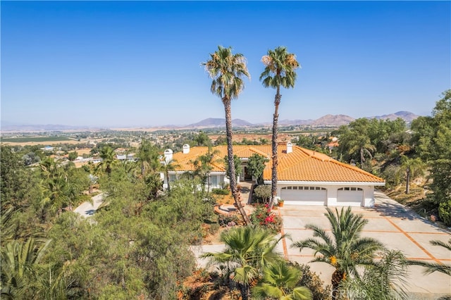 view of front of home with a garage and a mountain view