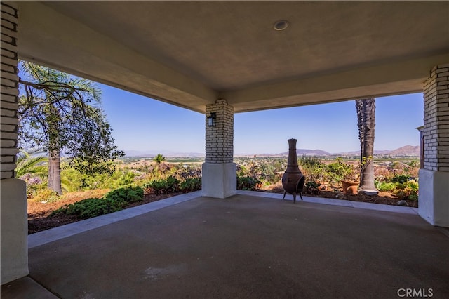 view of patio / terrace featuring a mountain view