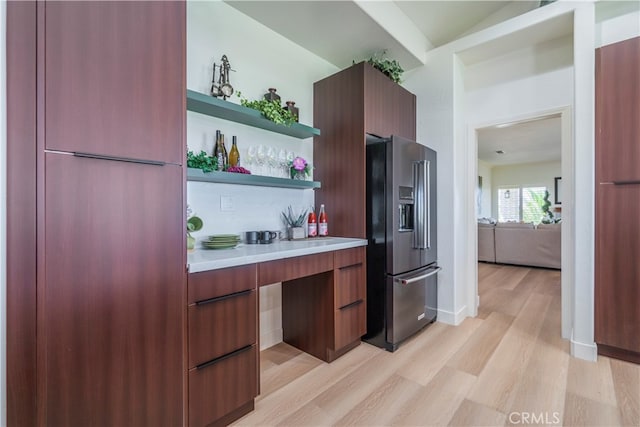 kitchen featuring high quality fridge and light hardwood / wood-style flooring