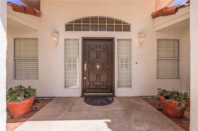 view of exterior entry featuring a patio area