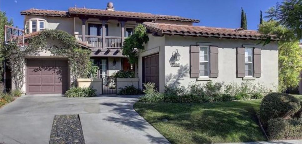 mediterranean / spanish-style home with a balcony, a front yard, and a garage