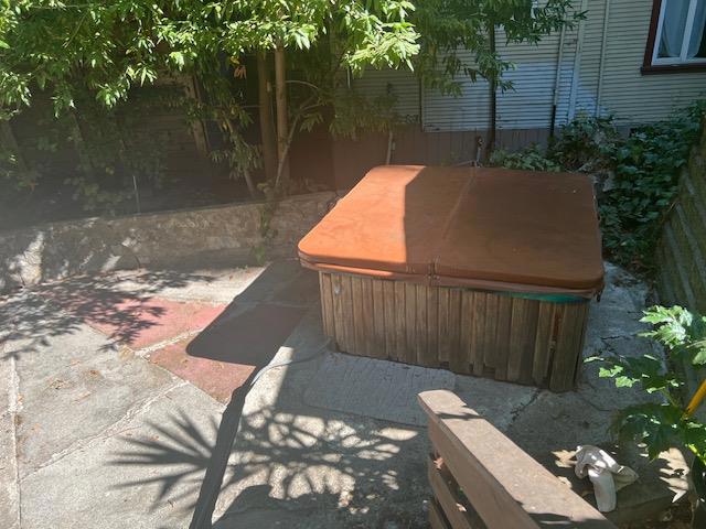 view of patio / terrace with a hot tub