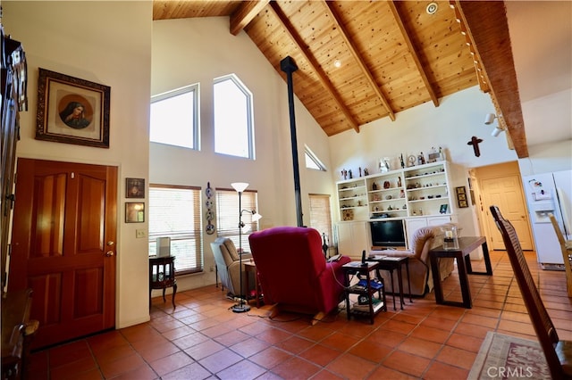 tiled living room with a wealth of natural light, beam ceiling, and high vaulted ceiling