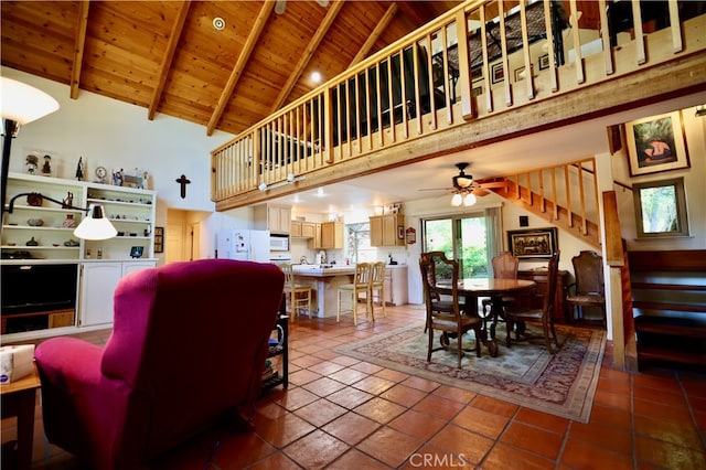 living room with ceiling fan, wood ceiling, beam ceiling, and high vaulted ceiling