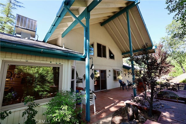 rear view of house featuring a wooden deck