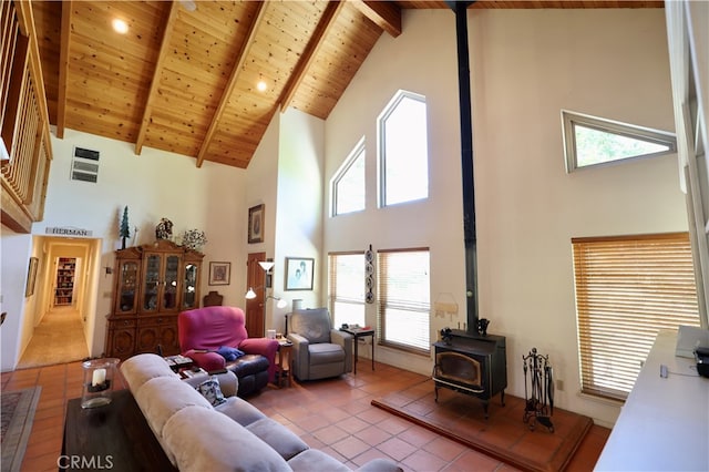 tiled living room with wooden ceiling, beamed ceiling, a wood stove, and high vaulted ceiling