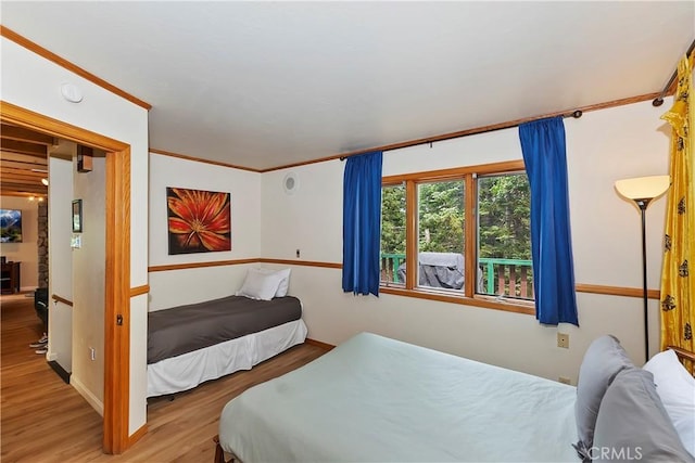 bedroom featuring ornamental molding and hardwood / wood-style floors