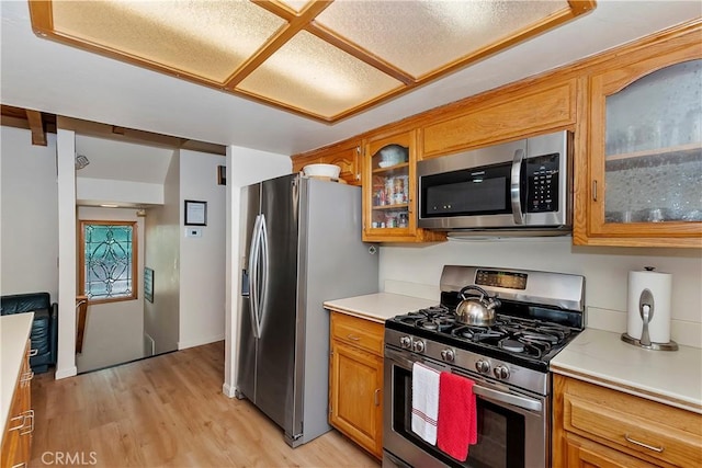 kitchen featuring appliances with stainless steel finishes and light hardwood / wood-style floors