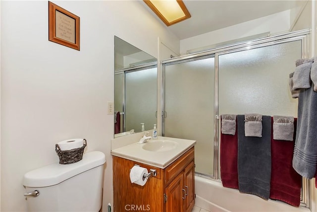 full bathroom featuring toilet, enclosed tub / shower combo, and vanity