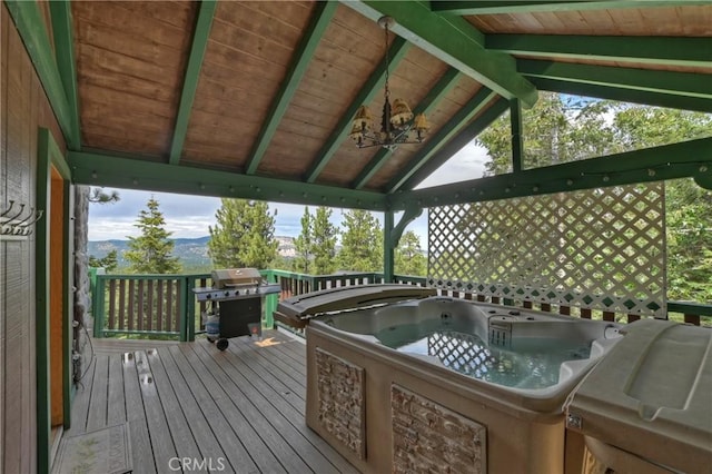 wooden deck featuring a mountain view, a gazebo, a hot tub, and a grill