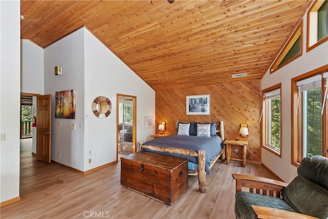 bedroom with light hardwood / wood-style floors, high vaulted ceiling, wood ceiling, and wooden walls