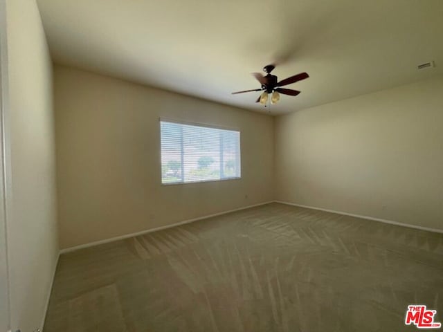 empty room with ceiling fan and carpet flooring