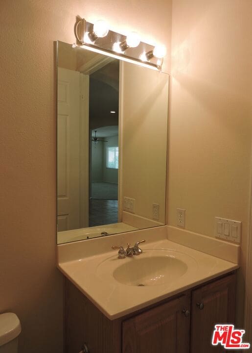 bathroom featuring vanity and toilet