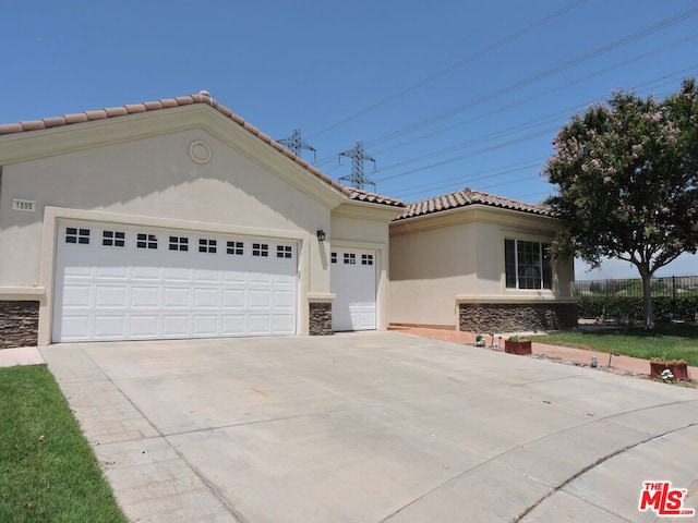 mediterranean / spanish house featuring a garage