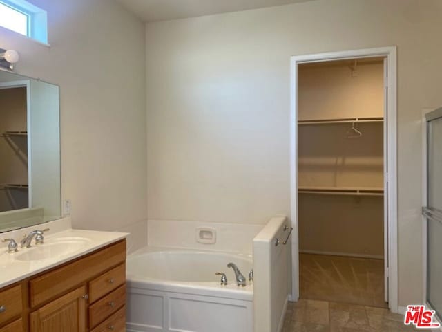 bathroom with vanity and a bathtub