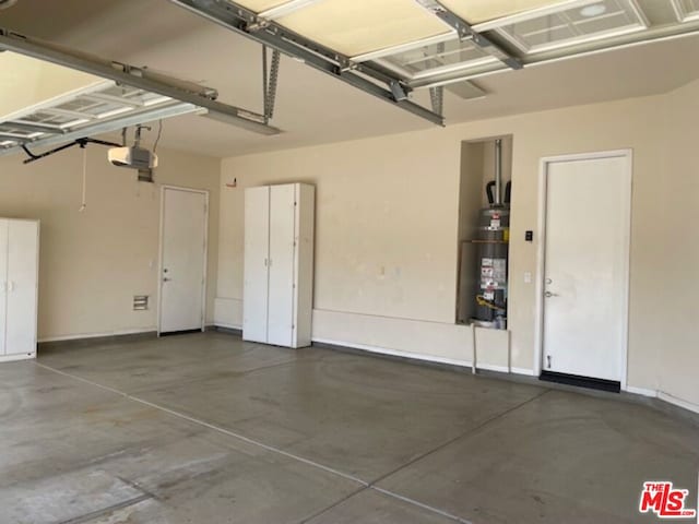 garage featuring secured water heater and a garage door opener