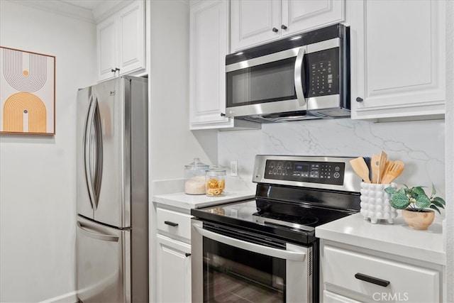 kitchen with appliances with stainless steel finishes, decorative backsplash, and white cabinetry