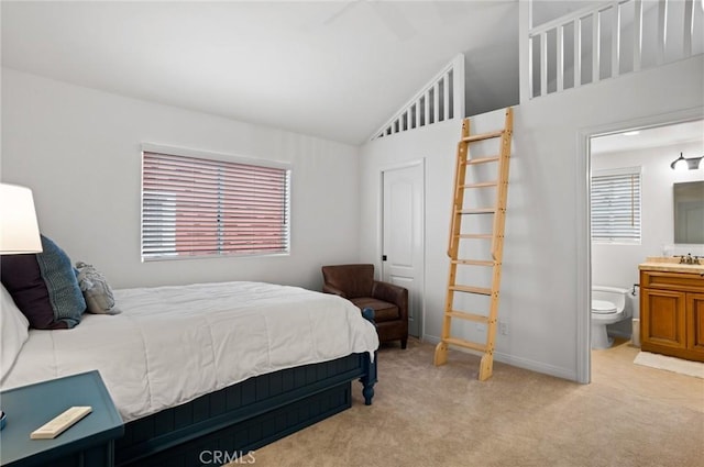 carpeted bedroom featuring ensuite bathroom, a closet, and lofted ceiling