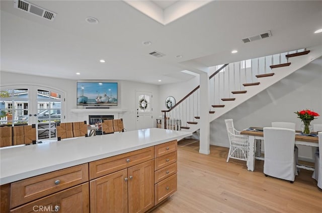 kitchen with french doors and light wood-type flooring