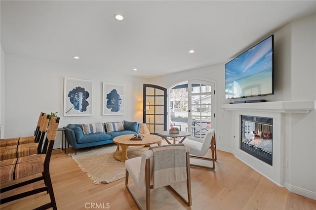 living room featuring french doors and light hardwood / wood-style flooring