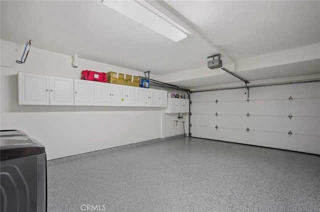 garage with washer / dryer and a garage door opener