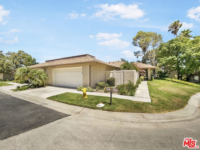 ranch-style home featuring a front lawn and a garage