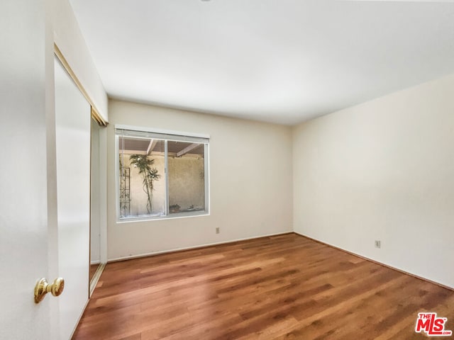 unfurnished room featuring hardwood / wood-style flooring