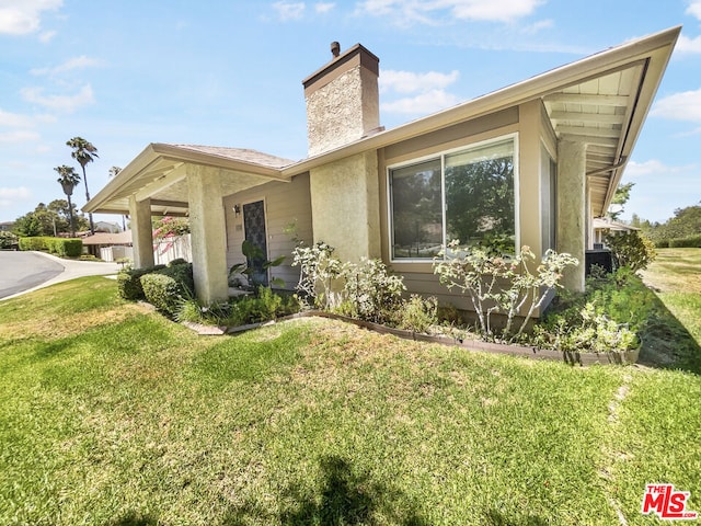 view of property exterior with a yard