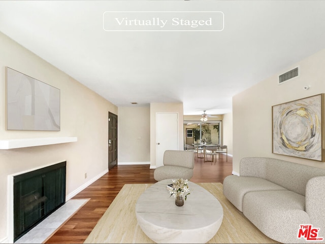 living room with hardwood / wood-style flooring and ceiling fan