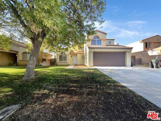 mediterranean / spanish house with a garage and a front lawn