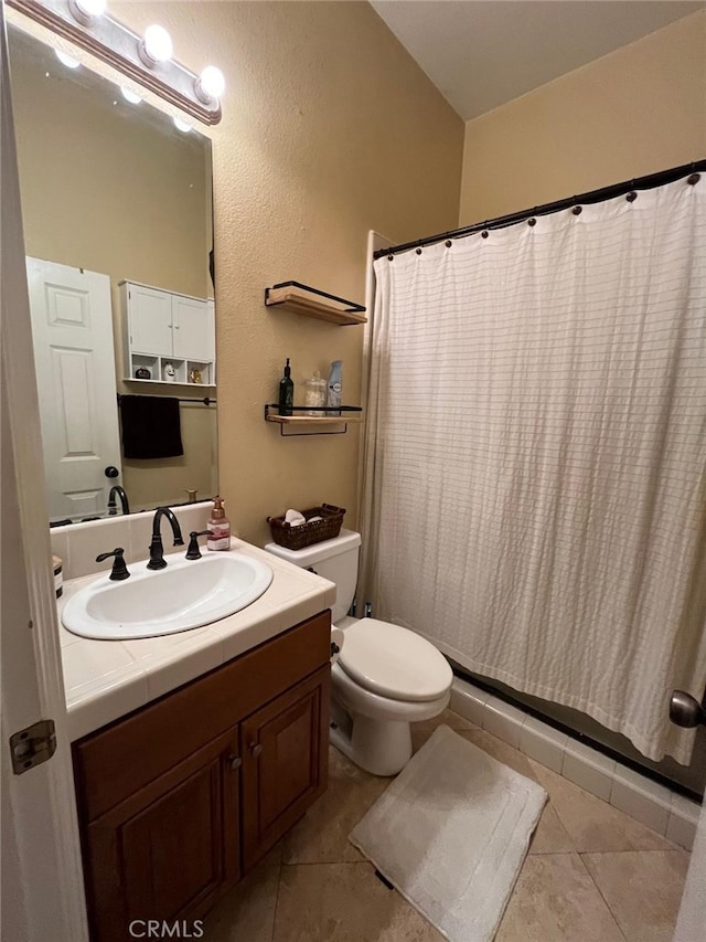 bathroom with vanity, toilet, a shower with shower curtain, and tile patterned floors