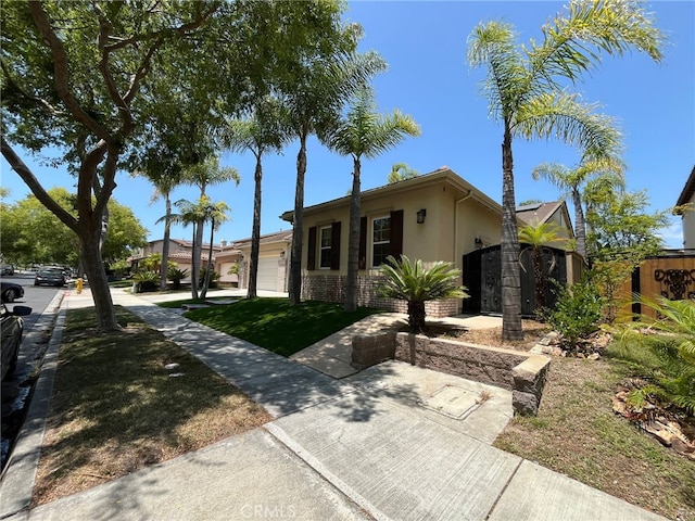 ranch-style home with a garage and a front lawn