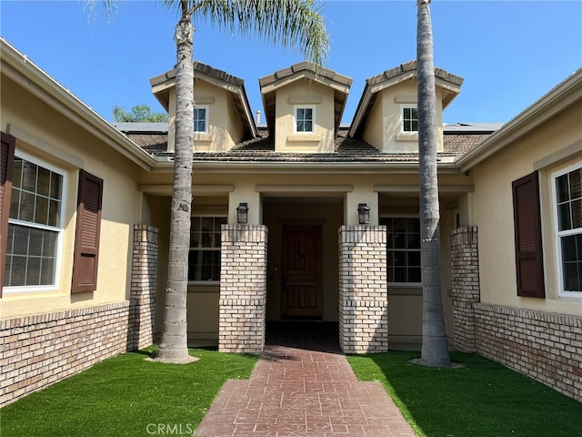 doorway to property with a yard