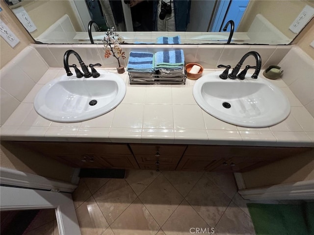 bathroom with tasteful backsplash, vanity, and tile patterned floors