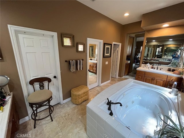 bathroom with vanity and a relaxing tiled tub