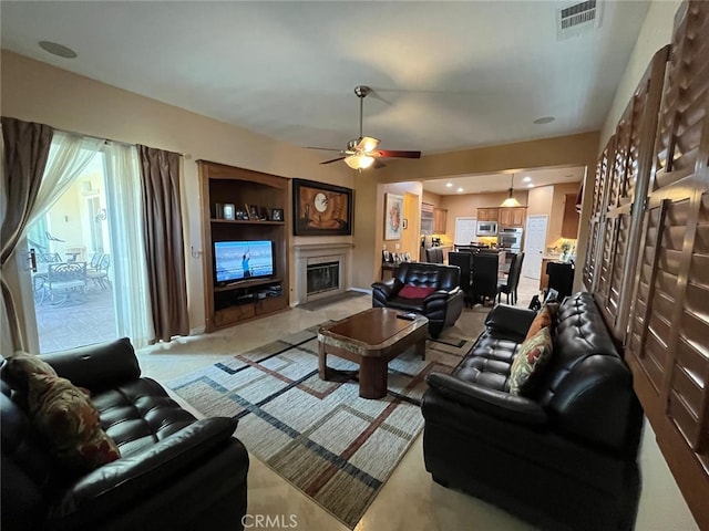 living room featuring ceiling fan and light colored carpet