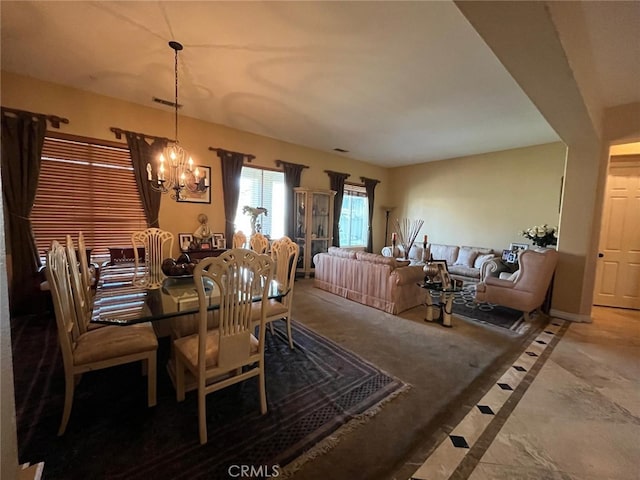 dining space with a chandelier