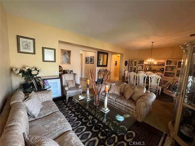 carpeted living room featuring a notable chandelier