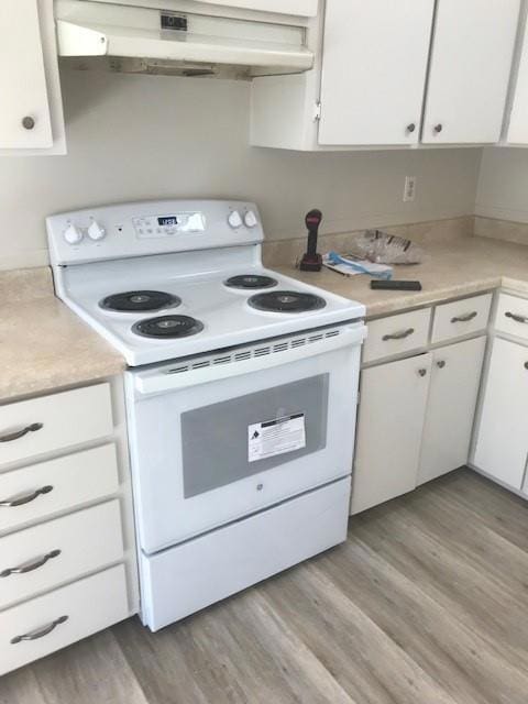 kitchen featuring white cabinetry, light hardwood / wood-style floors, and white range with electric cooktop