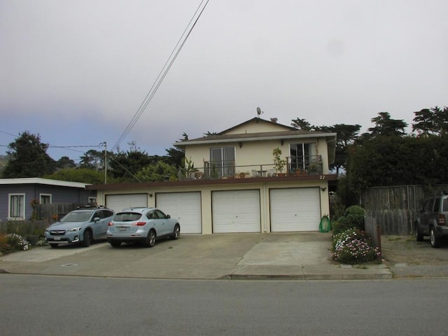 view of front property featuring a balcony and a garage