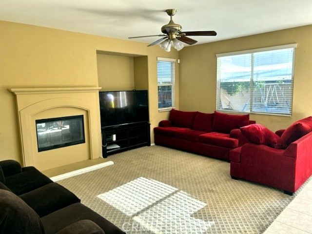 living room featuring ceiling fan and light carpet