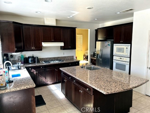 kitchen featuring a center island with sink, appliances with stainless steel finishes, and sink