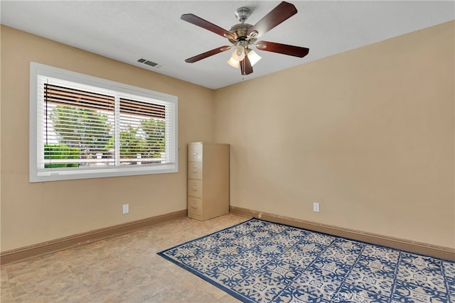 empty room featuring ceiling fan and a textured ceiling