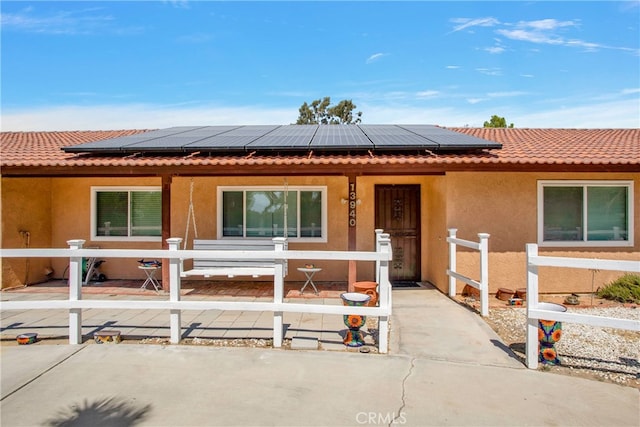 view of front of house featuring solar panels