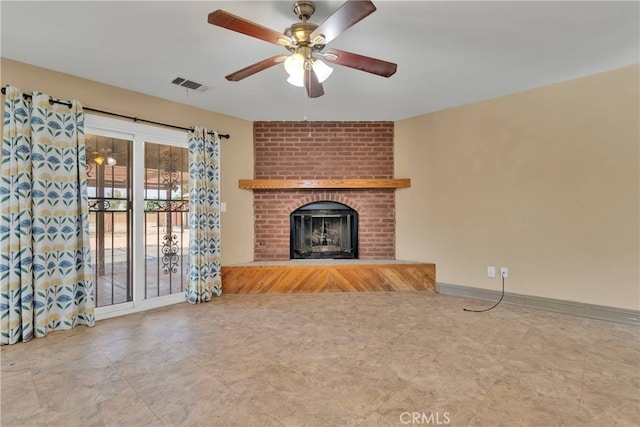 unfurnished living room with a brick fireplace and ceiling fan