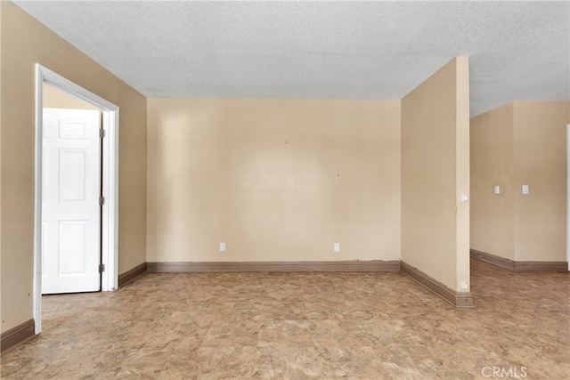 spare room with a textured ceiling