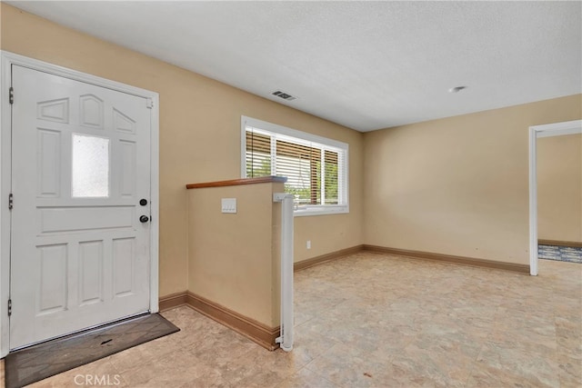 entryway with a textured ceiling