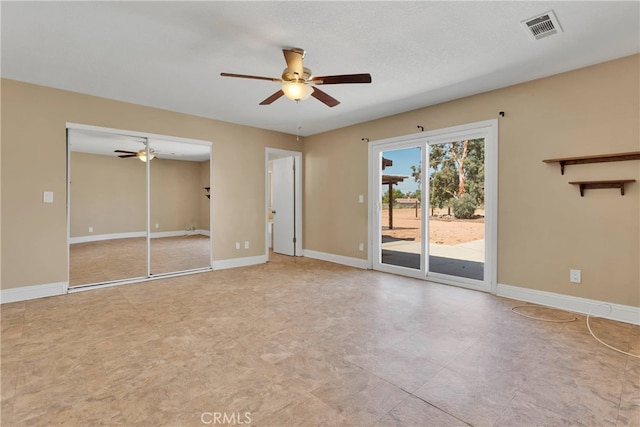 interior space featuring ceiling fan and a textured ceiling