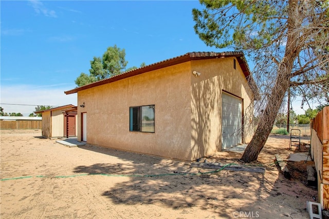 view of side of home featuring an outdoor structure