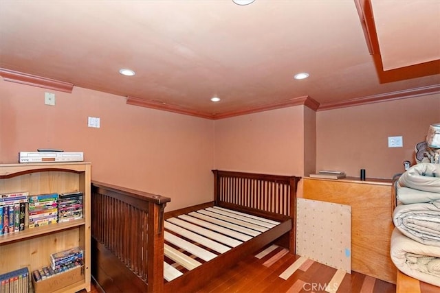 bedroom featuring ornamental molding and hardwood / wood-style floors